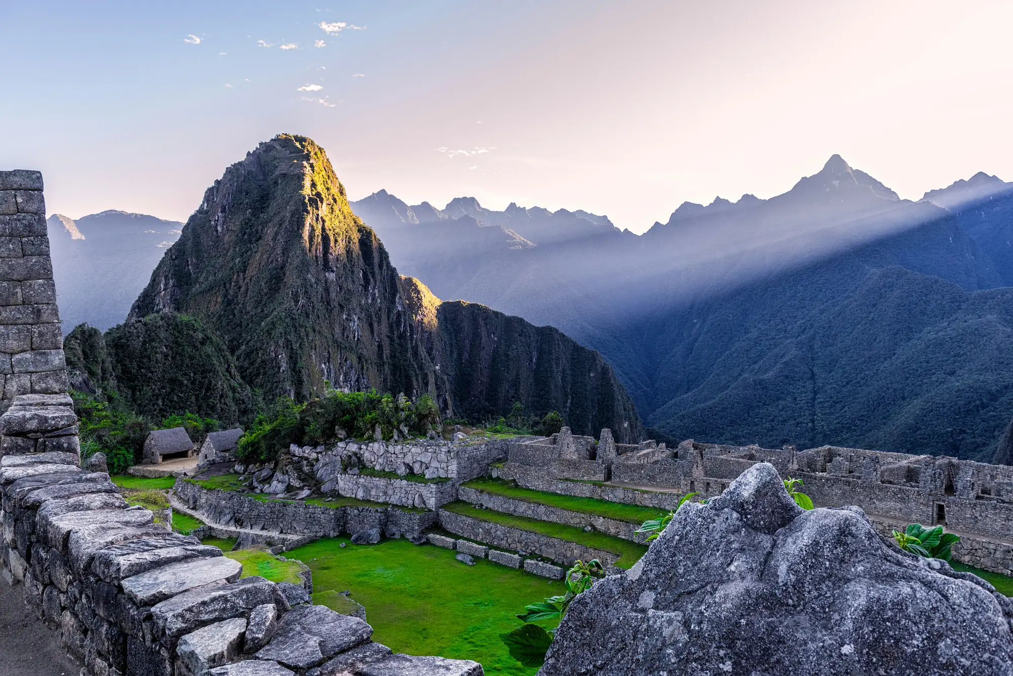 Inca stone terraces nex to the view of a mountain top